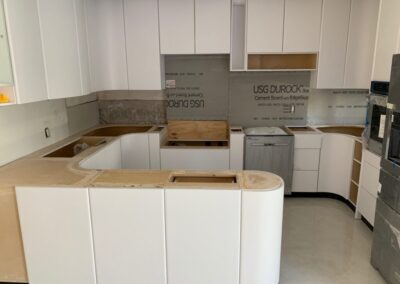 A kitchen with white cabinets and a counter top
