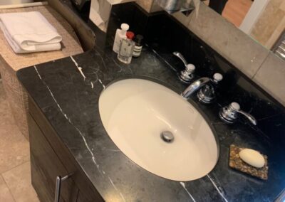 A man standing in a bathroom next to a sink