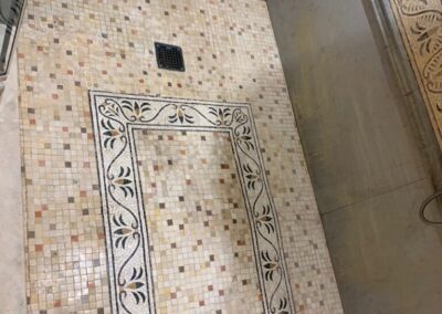 A bathroom with a tiled floor and walls