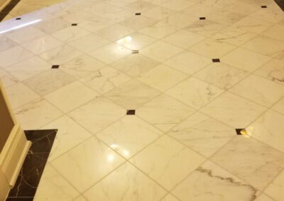 A white marble floor with black and white tile