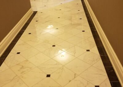 A white marble floor with black and white tiles