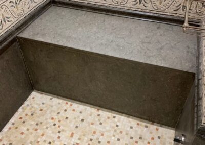 A bathroom with a tiled floor and walls