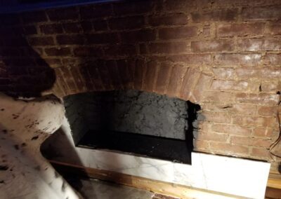 A brick oven in a room with a brick wall