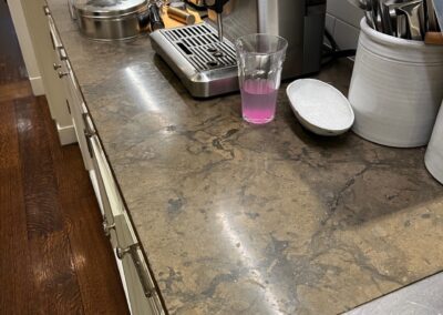 A kitchen counter with a coffee maker and other items on it