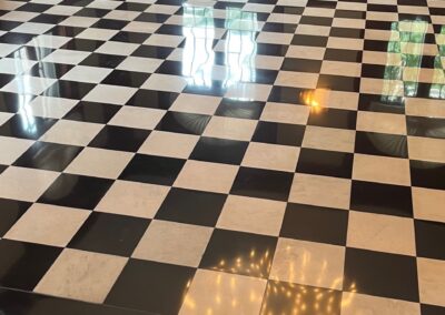 A black and white checkered floor with light shades on it